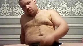 A gay man with an average body weight pleasuring himself