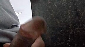 Bursting with desire in public bathroom stall.