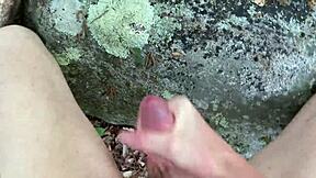 Guy masturbates in the woods, his excitement evident