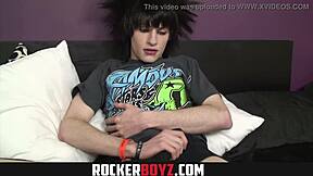 Emo twink wanks his cock while rocking out in a wild style
