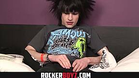 Emo twink wanks his cock while rocking out in a wild style