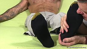 Hunk feels great while his feet are being licked by another guy