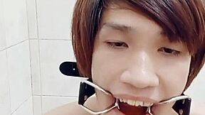 Skinny Thai gay Fagteetajet filled his ass with enema and butt plug in bathroom. Then he drank own piss during solo toy handjob as amateur lovers watched.